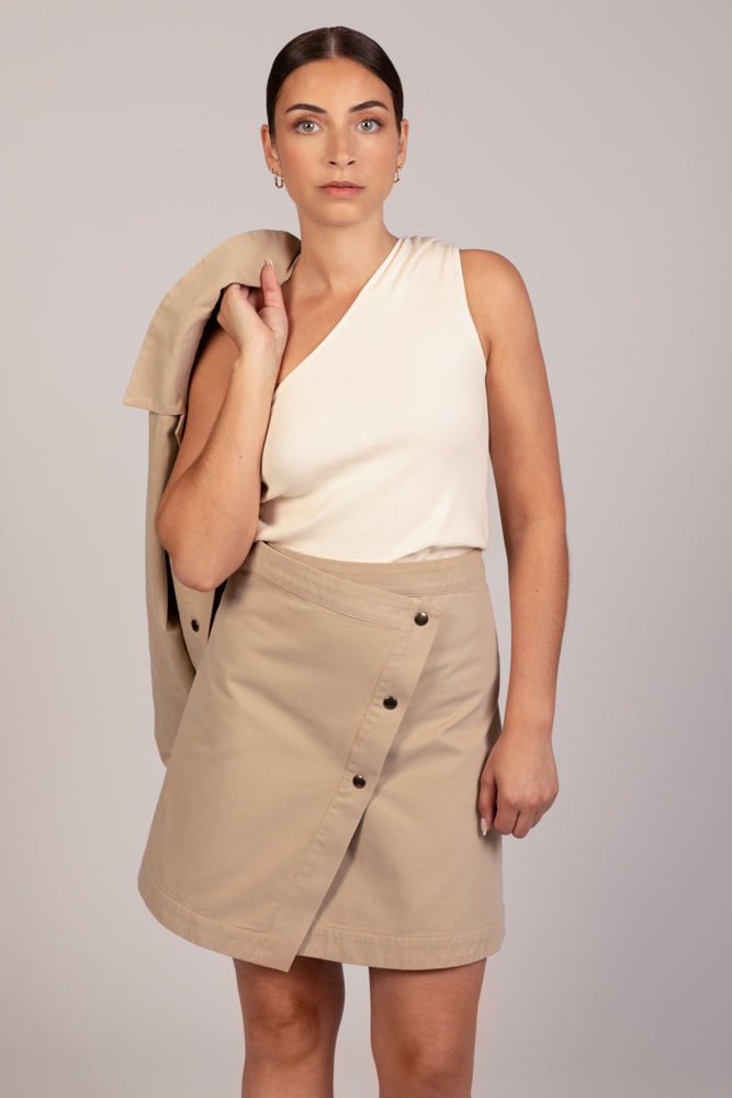 Jupe beige portefeuille mia avec top écru nova et veste beige droite ivy sur épaule, collection DILAA