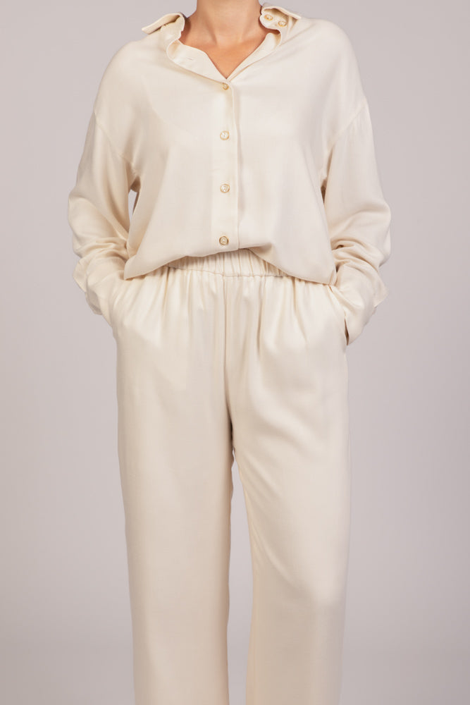 Pantalon écru MILO  fluide, coupe droite et taille élastique, porté avec la chemise   liberty écru assortie – collection été DILAA